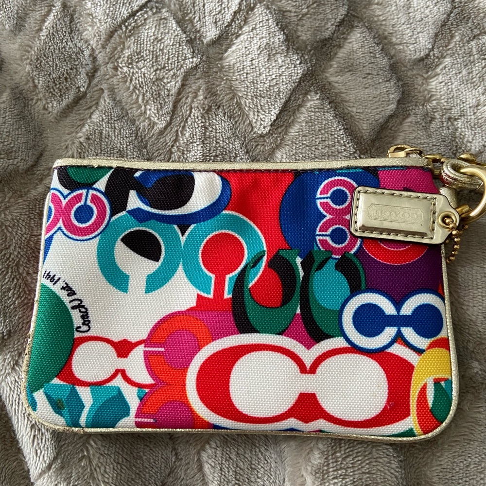 Coach Poppy wristlet with a multicolor graffiti-style